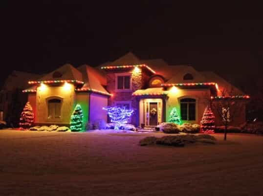 house with multi-colored exterior holiday lighting