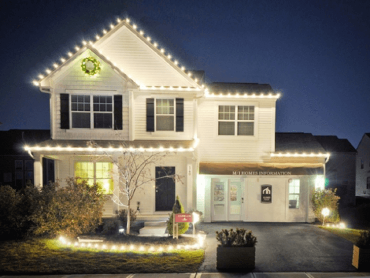 White home with holiday lighting